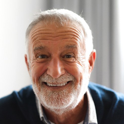 Senior man with beard smiling
