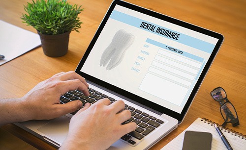 Patient filling out dental insurance form on computer