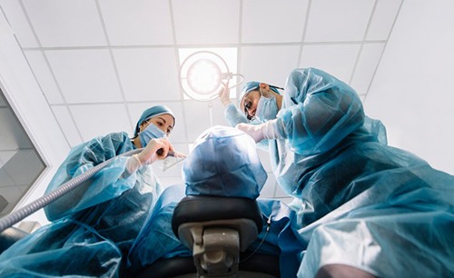 an oral surgeon performing dental implant placement