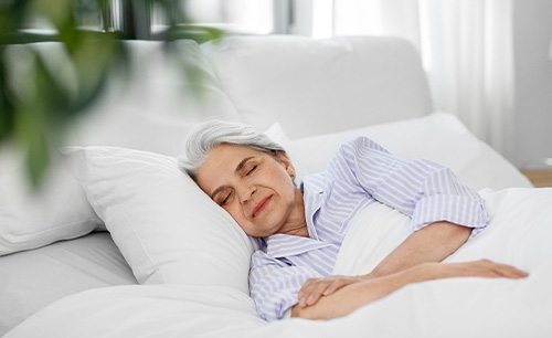 Senior woman sleeping soundly in bed