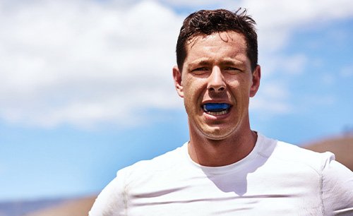 Man wears athletic mouthguard