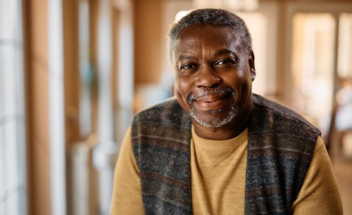 Smiling older man in a vest