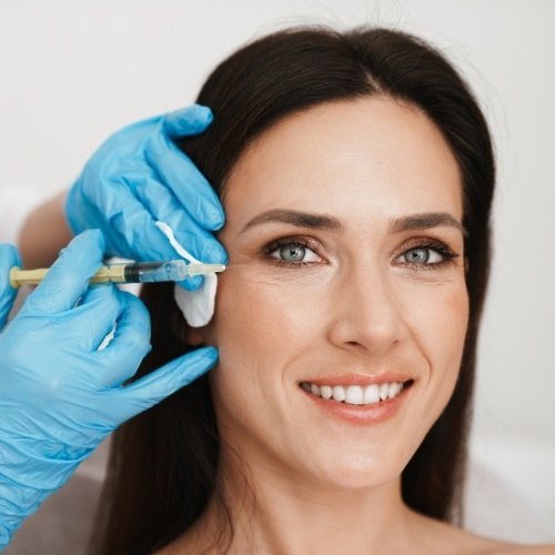 a dentist injecting BOTOX near the jaw line