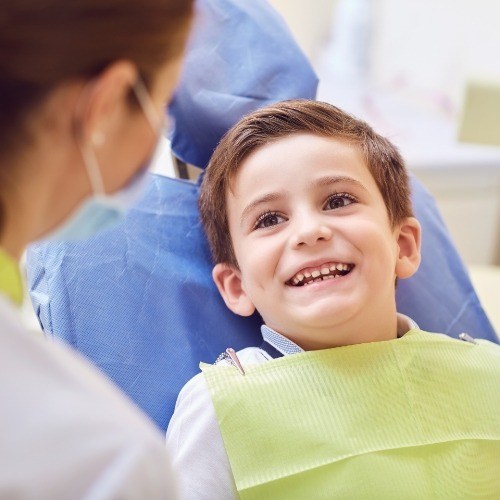 Child smiling during visit to the children's dentist