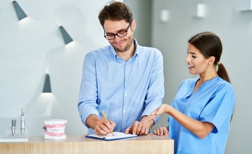 Dental team member explaining the cost of preparatory treatments