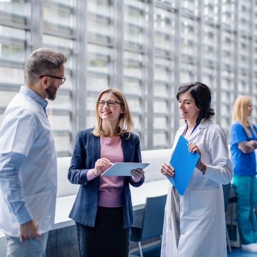 Dentist and dentistry team members discussing dental treatment plan