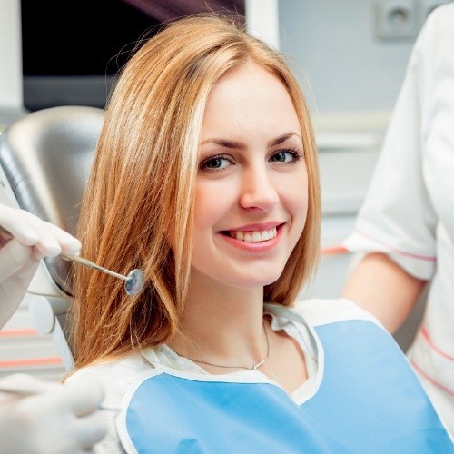 Dental patient smiling during dentistry treatment