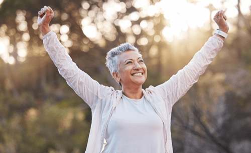 a mature woman smiling with dental implants in Columbia