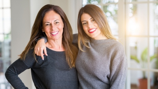 Mother and daughter in gray sweaters