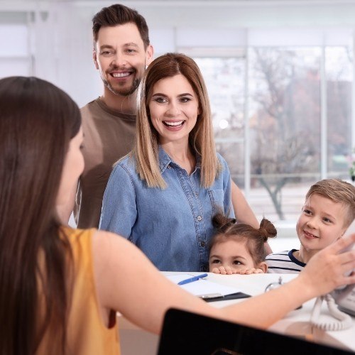 Family checking in at dental office