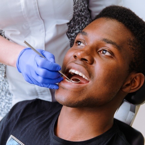 Dental patient receiving preventive dentistry checkup and teeth cleaning