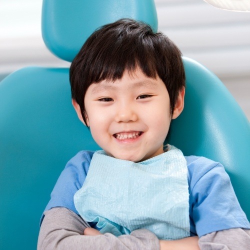 Child smiling during children's dentistry visit