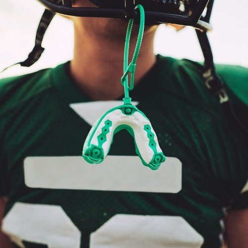 Athletic sportsguard hanging from football helmet