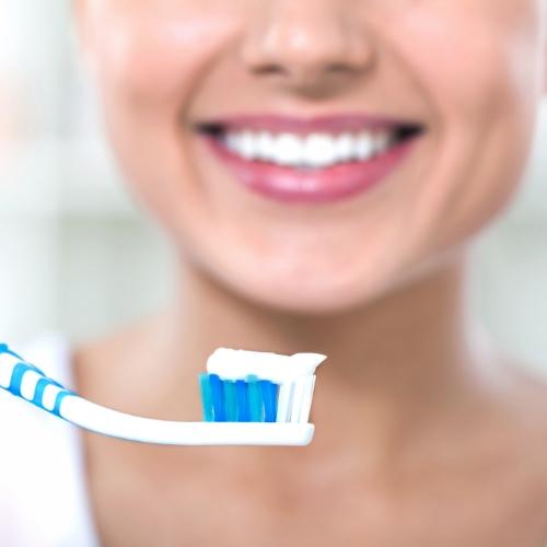 Dental patient brushing teeth to car for veneers