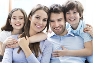 smiling parents and two kids