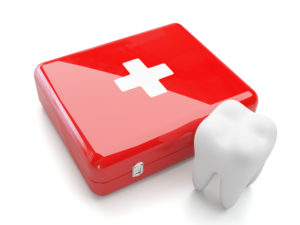 red first aid kit beside tooth