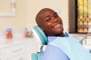 young man smiling in dental chair