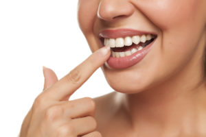 woman pointing to her teeth