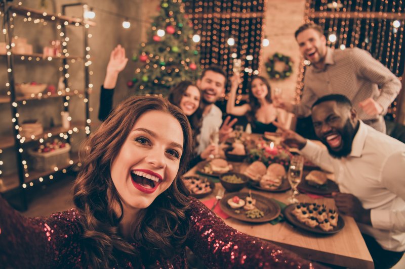 group of friends smiling at holiday event