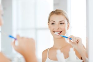 Woman brushing her teeth after visiting her dentist in Columbia