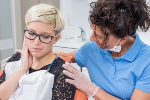 Woman experiencing pain at emergency dentist in Columbia.