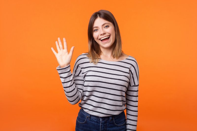 Girl smiling and waving