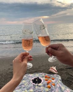 Couple drinking champagne at beach