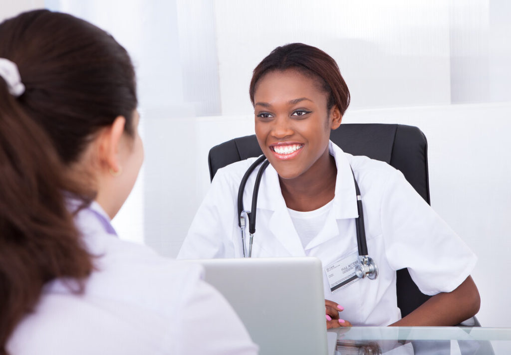 dentist speaking to patient at dental implant consultation