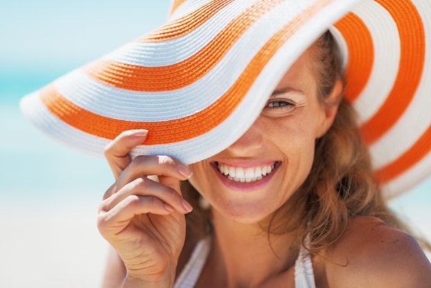 Woman smiling at the beach.