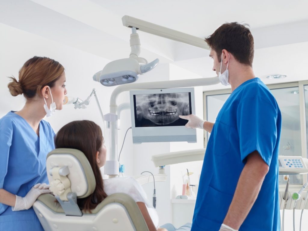 Patient receiving an X-ray at dentist's office.