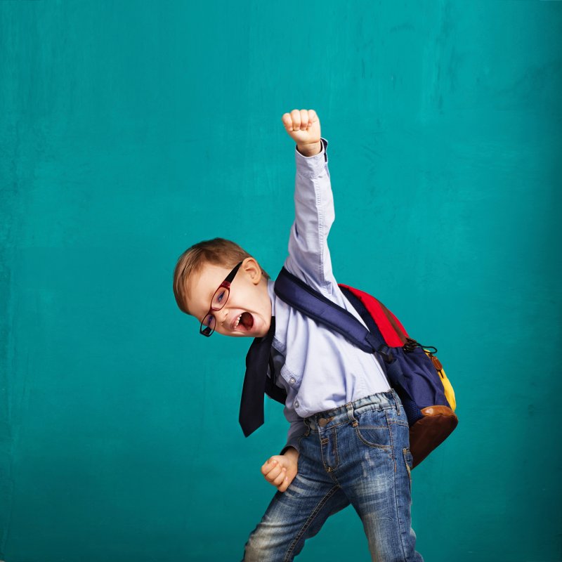 child celebrating visiting their dentist in Columbia