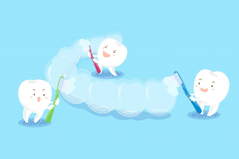 three cartoon teeth brushing an Invisalign tray