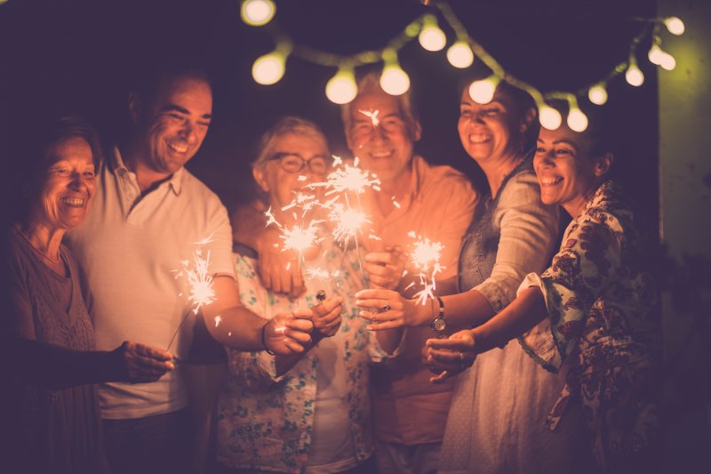 family holding new year’s sparklers