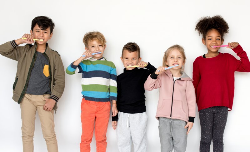 children happily brushing their teeth