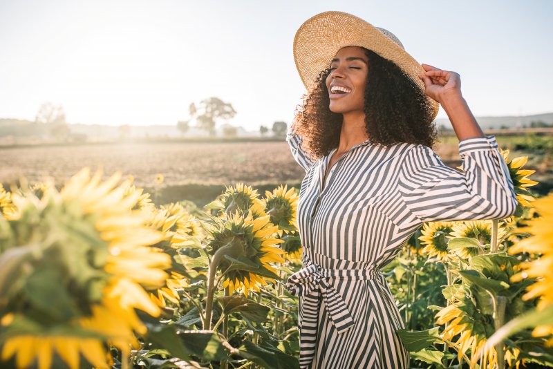 smiling woman standing in a field