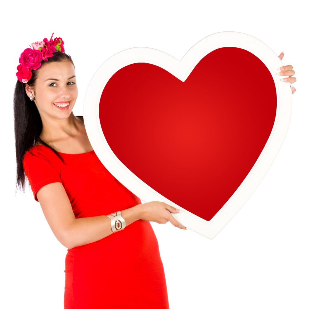 person holding a large paper heart