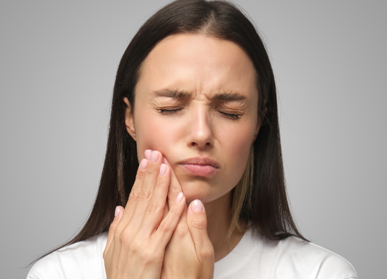 Woman holding jaw in pain